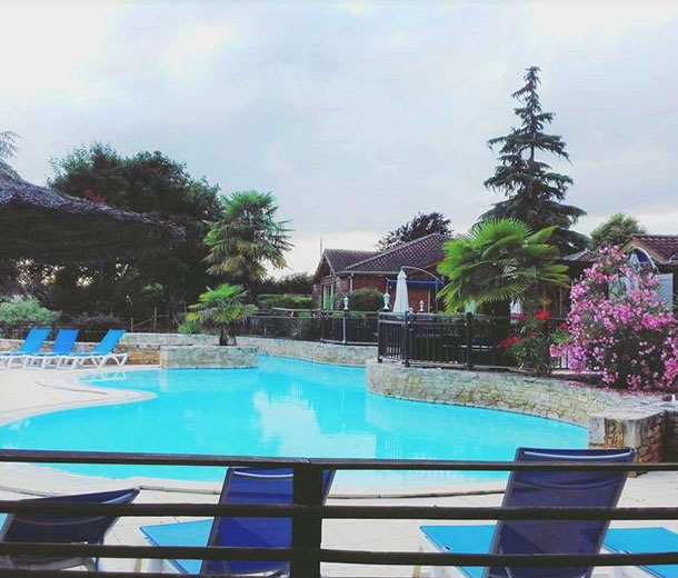 Intérieur du Domaine de Guillalmes à Fumel (47) : piscine extérieure, transats.